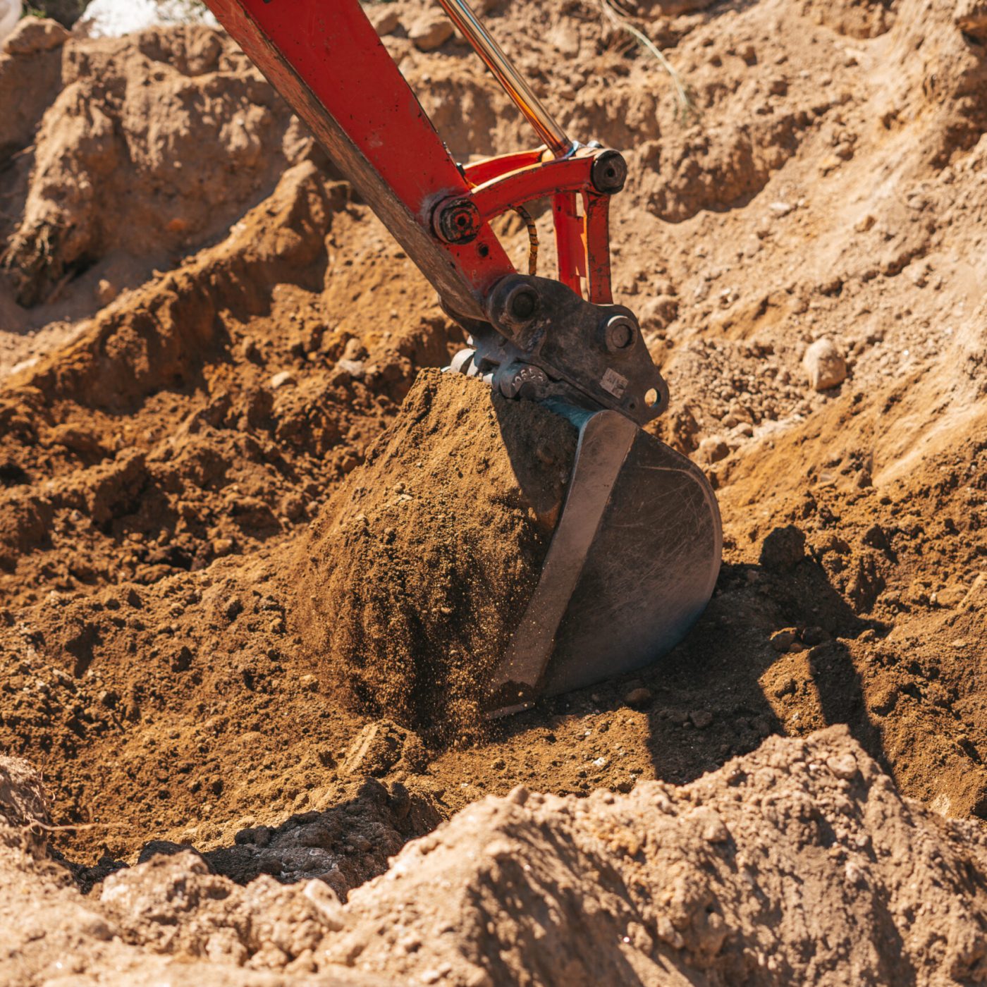 Excavator shovel digging on dirt on a construction site