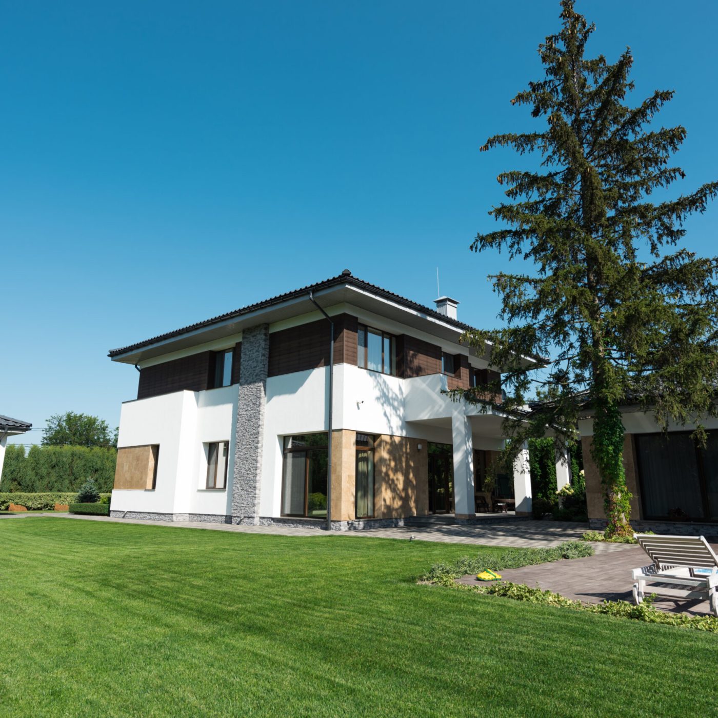 view of new modern house with swimming pool and green lawn